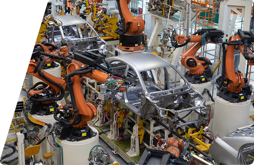 Automated orange robotic arms assembling a car body shell on a production line in a manufacturing factory.