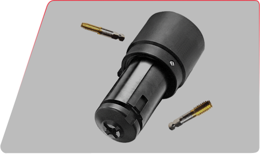 Industrial tap chuck tool holder with two golden threading taps floating nearby against a gray background.