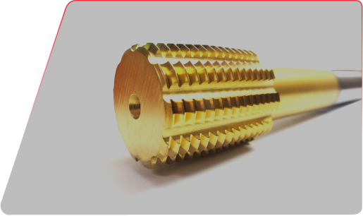 Close-up of a gold-colored metal reamer tool with serrated flutes and a central pilot hole.