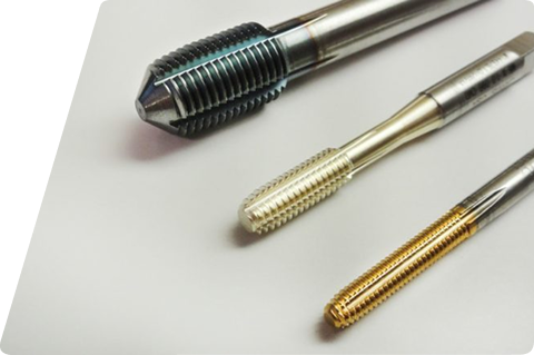 Three different metal cutting taps arranged diagonally on a white background.