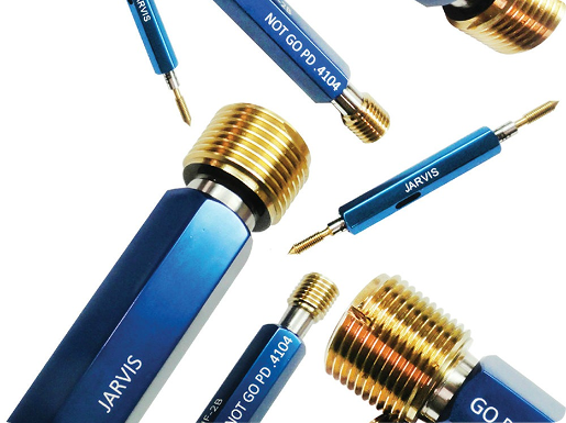 Several Jarvis brand blue handle thread plug gauges with brass and steel ends on a white background.